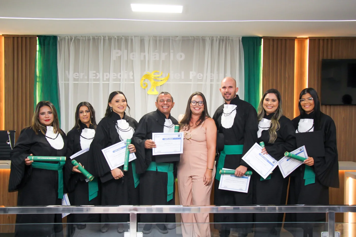 Turma em cerimônia de formatura com diplomas